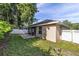 Backyard view featuring a screened lanai and brick patio; a tranquil outdoor space for relaxation and entertainment at 2127 Ne 38Th Ter, Ocala, FL 34470