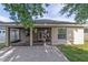 A backyard view featuring a brick patio, screened-in porch, and home exterior, perfect for outdoor relaxation at 2127 Ne 38Th Ter, Ocala, FL 34470