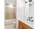 Bathroom featuring a single sink, wood cabinets and a tiled shower and tub at 2127 Ne 38Th Ter, Ocala, FL 34470