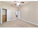 Bedroom with bi-fold closet, carpet, fan and access to bathroom at 2127 Ne 38Th Ter, Ocala, FL 34470
