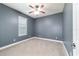 A cozy bedroom with neutral carpet and a ceiling fan at 2127 Ne 38Th Ter, Ocala, FL 34470