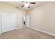 Bedroom with bi-fold closet, carpet, fan and access to bathroom at 2127 Ne 38Th Ter, Ocala, FL 34470