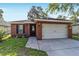 Charming single-story brick home with a well-manicured lawn and a two-car garage at 2127 Ne 38Th Ter, Ocala, FL 34470