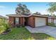 Charming single-story brick home with a well-manicured lawn and a two-car garage at 2127 Ne 38Th Ter, Ocala, FL 34470