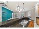 Modern kitchen featuring a granite breakfast bar overlooking a living room at 2127 Ne 38Th Ter, Ocala, FL 34470