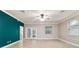 A bright living room featuring tile floors and French doors leading to the backyard at 2127 Ne 38Th Ter, Ocala, FL 34470