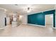 Open living room with tile floors, breakfast bar, and a colorful accent wall at 2127 Ne 38Th Ter, Ocala, FL 34470