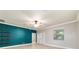 Bright living room with tile flooring, a ceiling fan, and built-in shelving on a teal accent wall at 2127 Ne 38Th Ter, Ocala, FL 34470