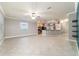 Bright and open living area featuring tile floors, kitchen with breakfast bar, and a ceiling fan at 2127 Ne 38Th Ter, Ocala, FL 34470