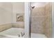 A bright main bath featuring a soaker tub and walk-in shower with beautiful tile surround at 2127 Ne 38Th Ter, Ocala, FL 34470