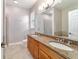 A luxurious main bath with double sinks, granite countertops, and a large mirror at 2127 Ne 38Th Ter, Ocala, FL 34470