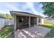Screened patio and exterior view show backyard with brick patio and well-maintained landscaping, ideal for outdoor living at 2127 Ne 38Th Ter, Ocala, FL 34470