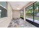 Enclosed patio featuring slate-look tile flooring, screened windows and ceiling fan at 2127 Ne 38Th Ter, Ocala, FL 34470