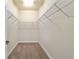 A spacious walk-in closet with ample storage space on metal racks, perfect for organizing clothes and accessories at 2127 Ne 38Th Ter, Ocala, FL 34470