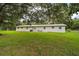 A sprawling backyard shows an expansive lawn perfect for outdoor activities and relaxation at 2155 Nw 27Th Ave, Ocala, FL 34475
