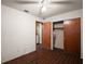Tiled bedroom with ceiling fan, closet, door, and open doorway to other rooms in the house at 2155 Nw 27Th Ave, Ocala, FL 34475
