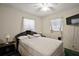 This bedroom offers a cozy retreat with bright windows, a ceiling fan, and ample space at 2155 Nw 27Th Ave, Ocala, FL 34475