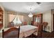 Spacious dining room with a chandelier, wood flooring, a large window, and antique furnishings at 2155 Nw 27Th Ave, Ocala, FL 34475