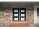 Inviting front entry with double doors and brick facade offers a unique architectural detail at 2155 Nw 27Th Ave, Ocala, FL 34475