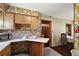 Retro kitchen with yellow cabinetry, floral wallpaper, and a white countertop with a small breakfast bar area at 2155 Nw 27Th Ave, Ocala, FL 34475