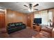 Living area with a comfortable couch, TV, and wood-paneled walls at 2155 Nw 27Th Ave, Ocala, FL 34475