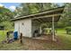 Outbuilding in the backyard provides ample storage and work space with attached carport at 2155 Nw 27Th Ave, Ocala, FL 34475