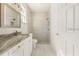 Modern bathroom featuring granite counters, single vanity, and a tiled walk-in shower at 2283 Sw 140Th Ct, Ocala, FL 34481