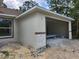Exterior view of the home featuring a 2-car garage and stone accents at 2283 Sw 140Th Ct, Ocala, FL 34481