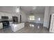 Open-concept living space featuring tile floors, kitchen island, and ample natural light at 2283 Sw 140Th Ct, Ocala, FL 34481