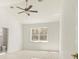 Spacious main bedroom featuring vaulted ceiling, ceiling fan, and ensuite bathroom at 2283 Sw 140Th Ct, Ocala, FL 34481