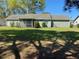 A lush backyard featuring a well-maintained lawn and mature trees on a sunny day at 3381 Nw 44Th Ct, Ocala, FL 34482