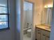 Bathroom with white tile, bath tub, modern mirror, sink and vanity at 3381 Nw 44Th Ct, Ocala, FL 34482