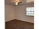 A serene bedroom featuring wood floors, a ceiling fan, and a window for natural light at 3381 Nw 44Th Ct, Ocala, FL 34482