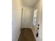 Clean entryway featuring wood-look flooring, a white door, and a window with blinds at 3381 Nw 44Th Ct, Ocala, FL 34482