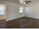 Spacious living room with wood-look flooring and windows for ample natural light at 3381 Nw 44Th Ct, Ocala, FL 34482