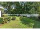 Lush backyard with a white privacy fence and manicured shrubbery, offering a serene outdoor space at 3515 Ne 43Rd Pl, Ocala, FL 34479