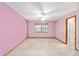 Bright bedroom with light pink walls, tile flooring and a ceiling fan at 3515 Ne 43Rd Pl, Ocala, FL 34479