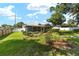 Charming single-story home with a screened-in porch and a well-manicured lawn at 3515 Ne 43Rd Pl, Ocala, FL 34479