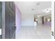 Bright entryway with neutral tile flooring, light purple accent wall, and view to the living area at 3515 Ne 43Rd Pl, Ocala, FL 34479