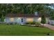 Charming single-story home featuring a manicured lawn, flower beds and a welcoming entryway at 3515 Ne 43Rd Pl, Ocala, FL 34479