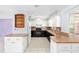 Bright kitchen featuring white upper cabinets, dark lower cabinets, and modern appliances at 3515 Ne 43Rd Pl, Ocala, FL 34479