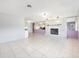 Spacious living room featuring tile floors, fireplace, and views to the kitchen at 3515 Ne 43Rd Pl, Ocala, FL 34479