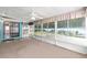 The airy sunroom is surrounded by windows and features carpeting and outdoor views at 3515 Ne 43Rd Pl, Ocala, FL 34479