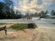 Charming single-story home featuring a white picket fence and attached two-car garage on a landscaped lot at 43 Pine Run, Ocala, FL 34472