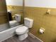This bathroom includes a toilet, shower with glass door, and yellow tile at 4701 Ne 9Th St, Ocala, FL 34470