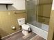 Cozy bathroom with tiled walls, toilet, and bathtub and shower combination at 4701 Ne 9Th St, Ocala, FL 34470