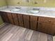 Bathroom with a double sink vanity featuring wooden cabinets and a marble countertop at 4701 Ne 9Th St, Ocala, FL 34470