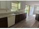 Functional kitchen featuring stainless steel sink and plentiful counter space with access to the screened in patio at 4701 Ne 9Th St, Ocala, FL 34470
