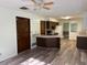 Open-concept kitchen with dark cabinets, new floors, and appliances in a cozy layout at 4701 Ne 9Th St, Ocala, FL 34470