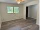 Bright living room features neutral walls, new floors, and natural light from a large window at 4701 Ne 9Th St, Ocala, FL 34470